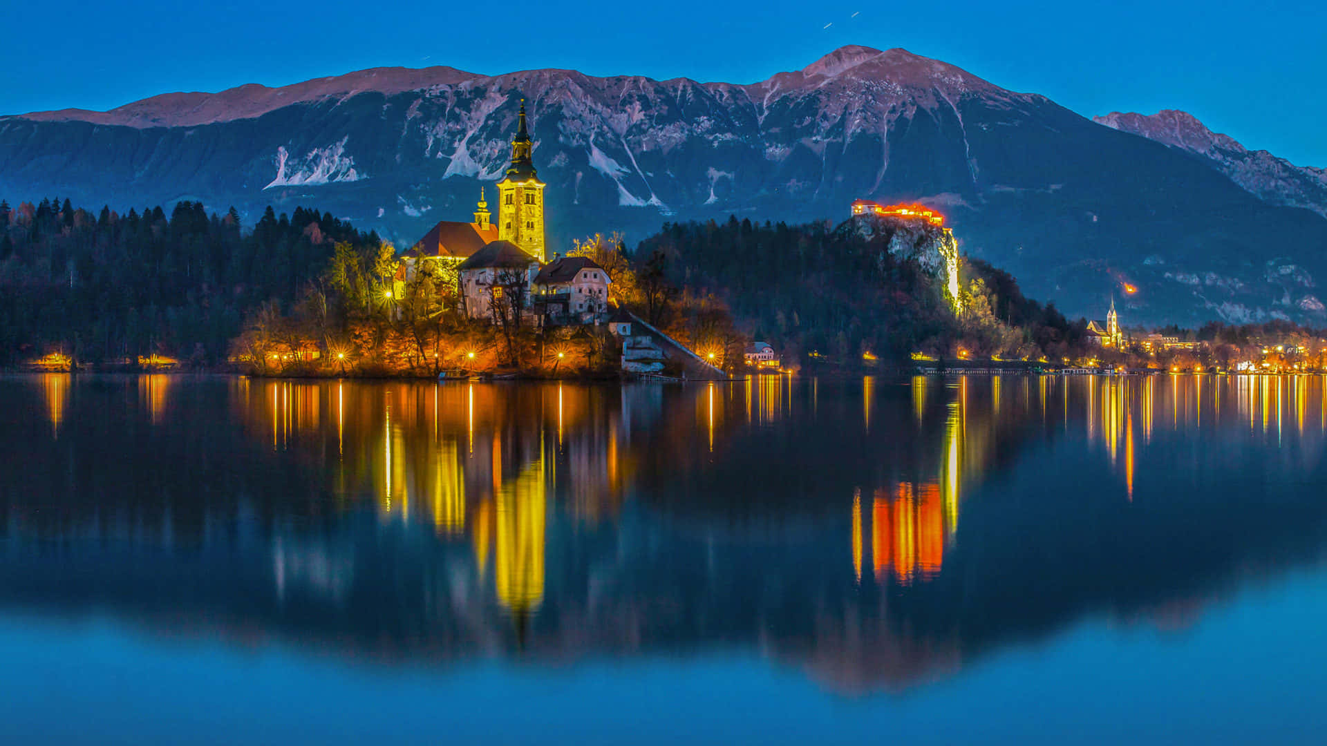 Stunning Lights Illuminating Lake Bled's Church Wallpaper