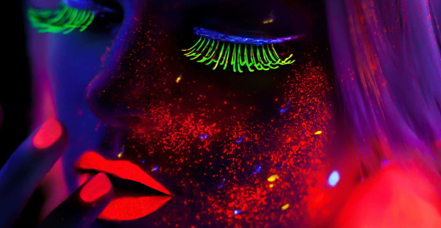 Stunning Neon Makeup Glowing Under Black Light Wallpaper