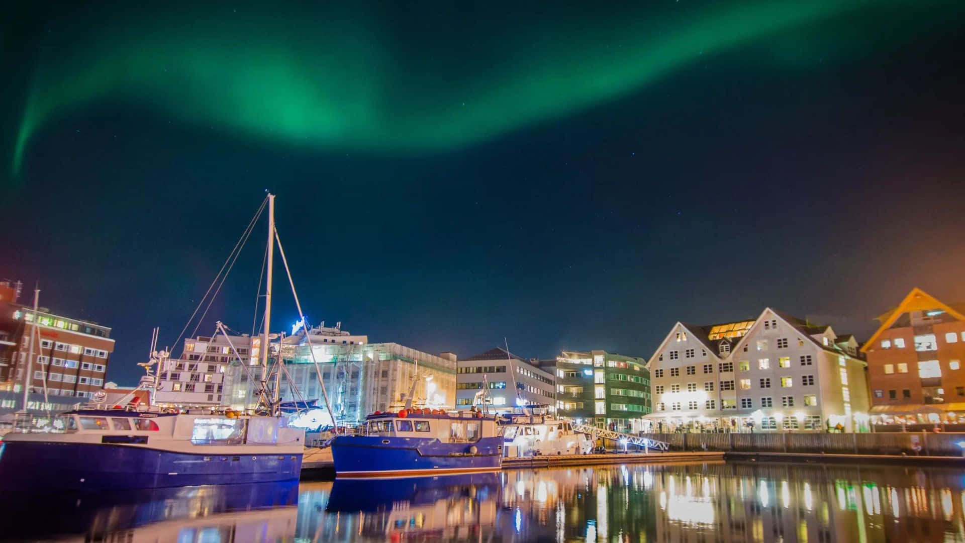 Stunning Night View Of Tromsø With Northern Lights Wallpaper