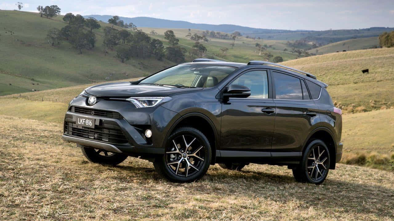 Stunning Silver Toyota Rav4 In Rugged Terrain Wallpaper