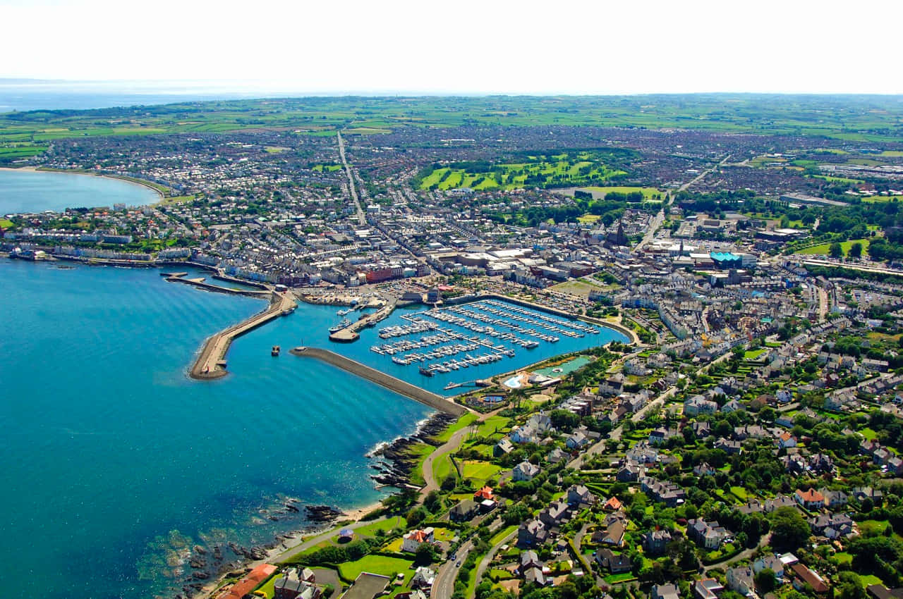 Stunning View Of Bangor, United Kingdom, Overlooking The Serene Water And Captivating City Skyline Wallpaper