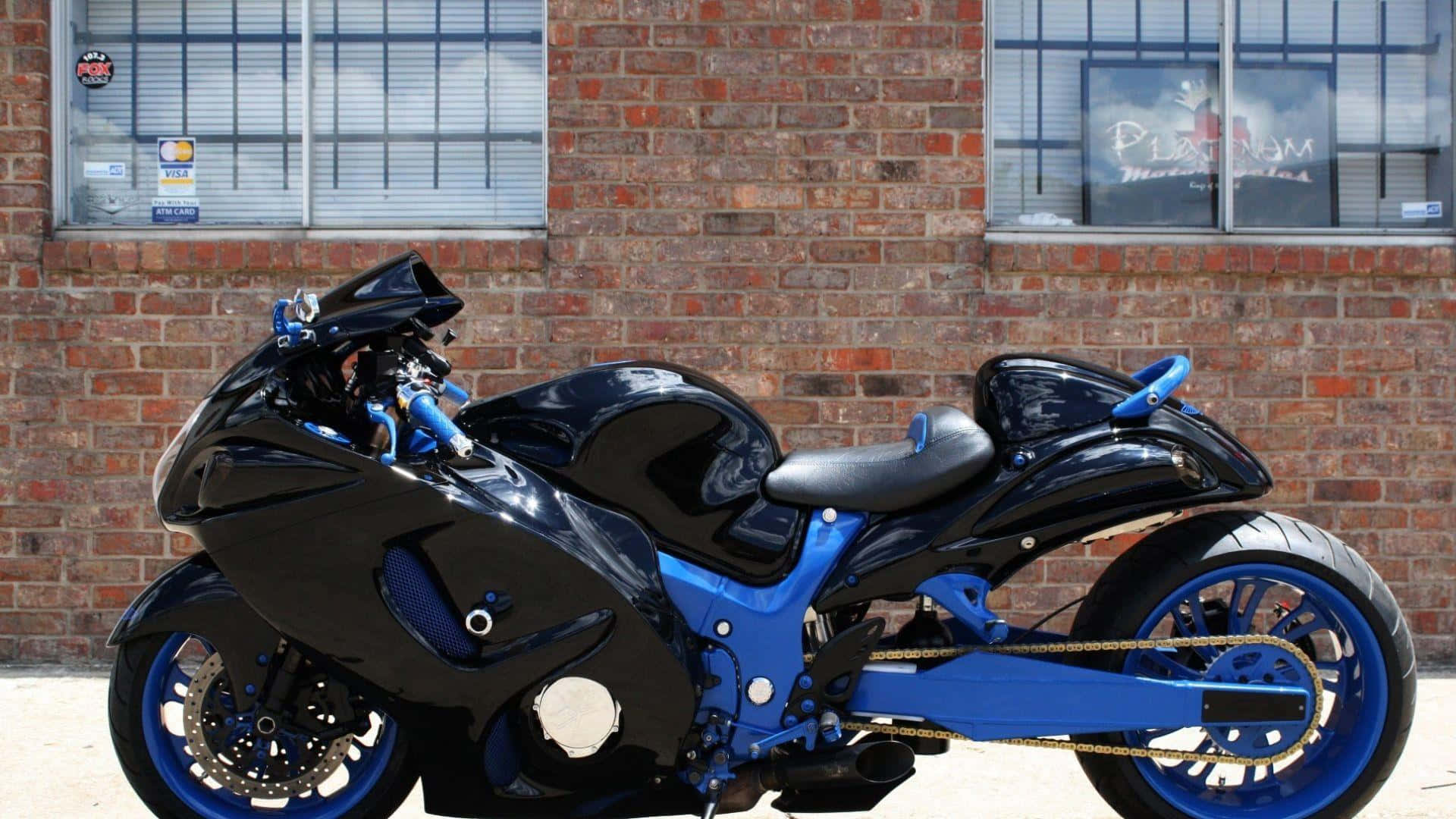 A Motorcycle Parked In Front Of A Brick Building
