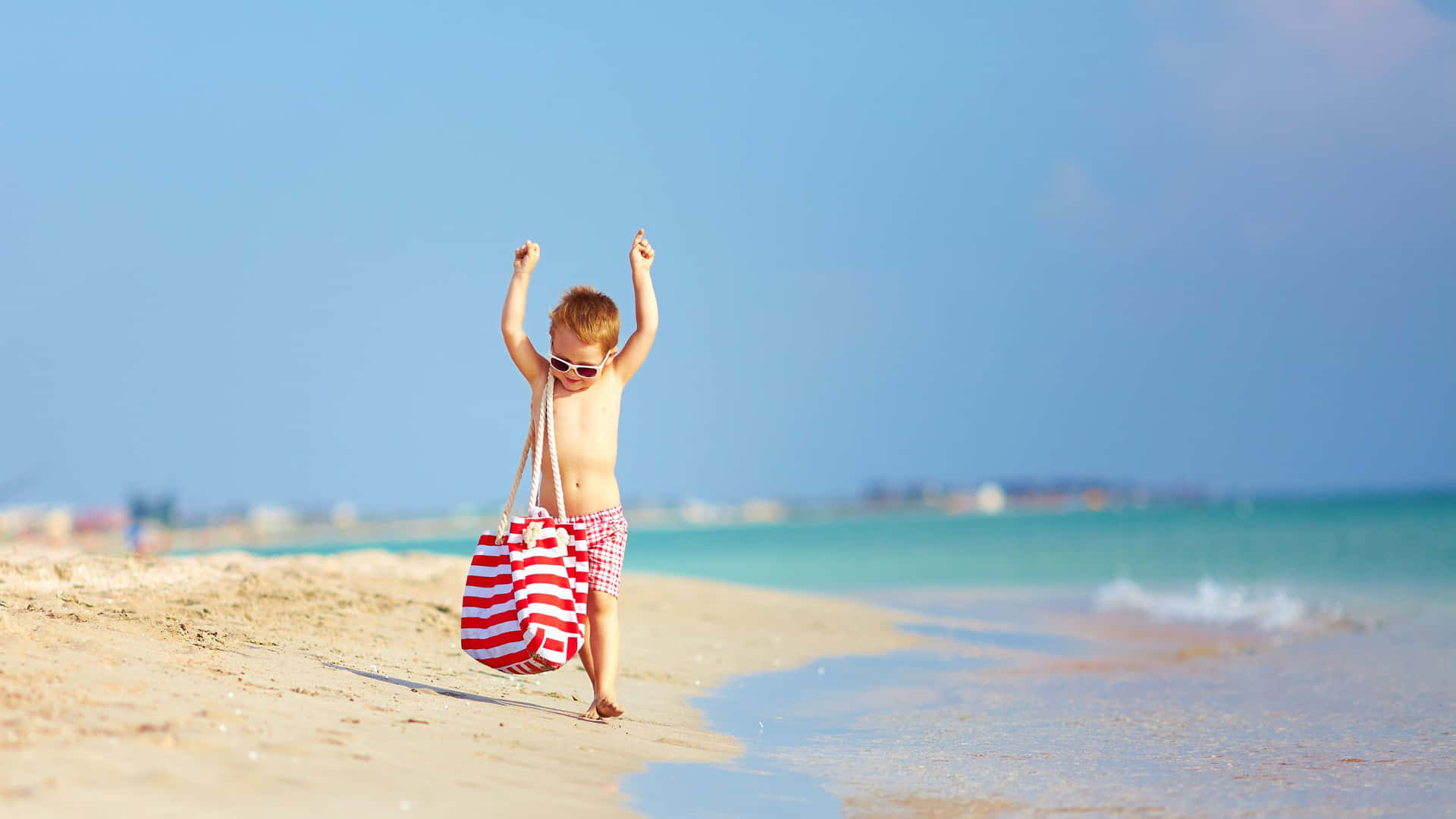 Stylish Boy Enjoying a Day at the Beach in a Trendy Summer Outfit Wallpaper