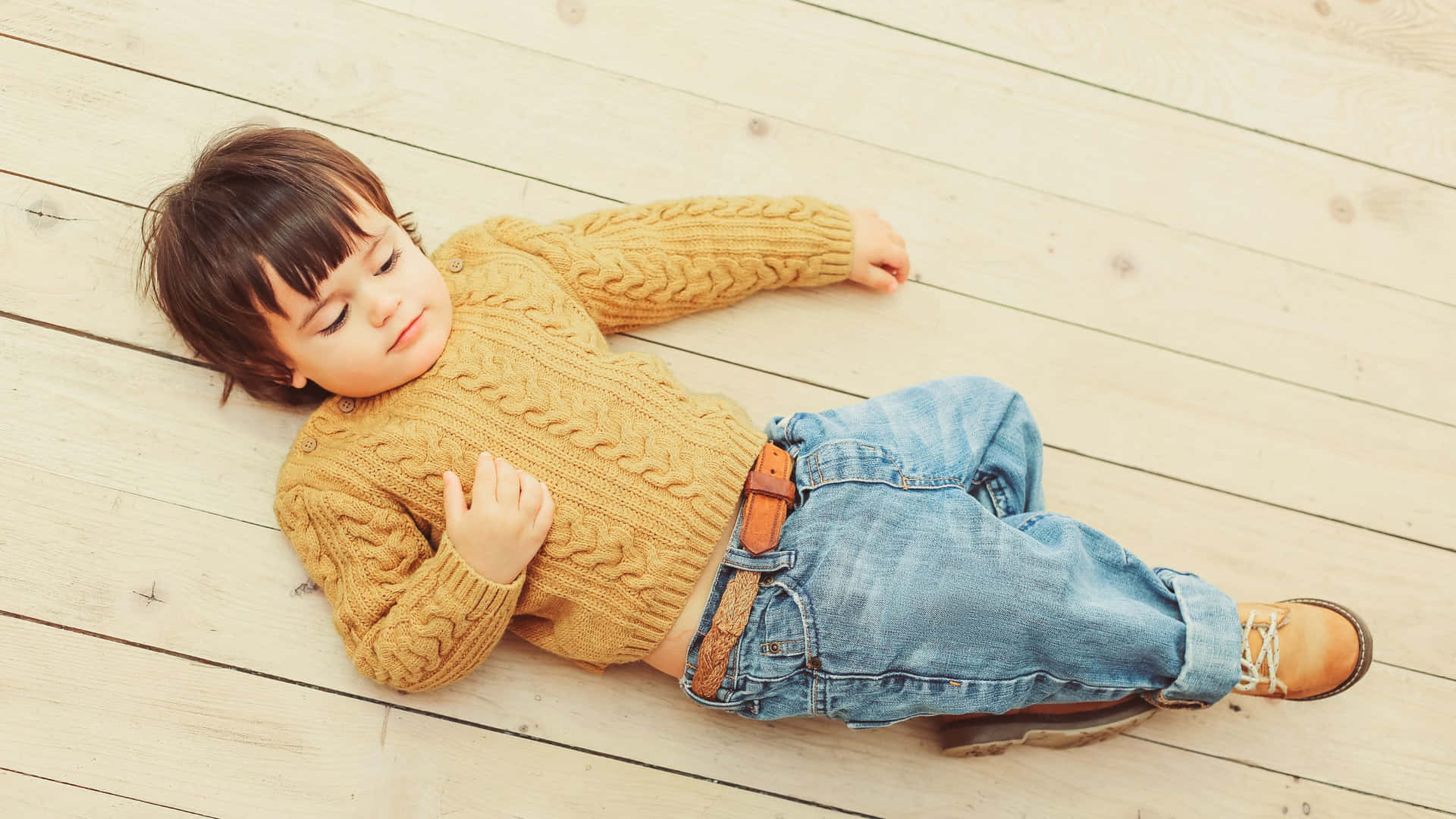 Stylish Boy Lying On Wood Wallpaper
