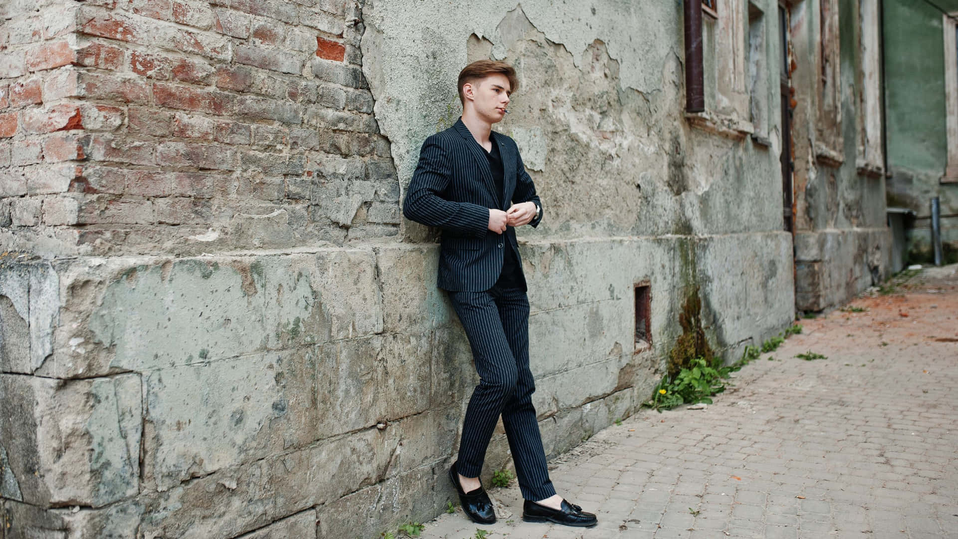 Elegant Young Man in Classy Black Suit Wallpaper