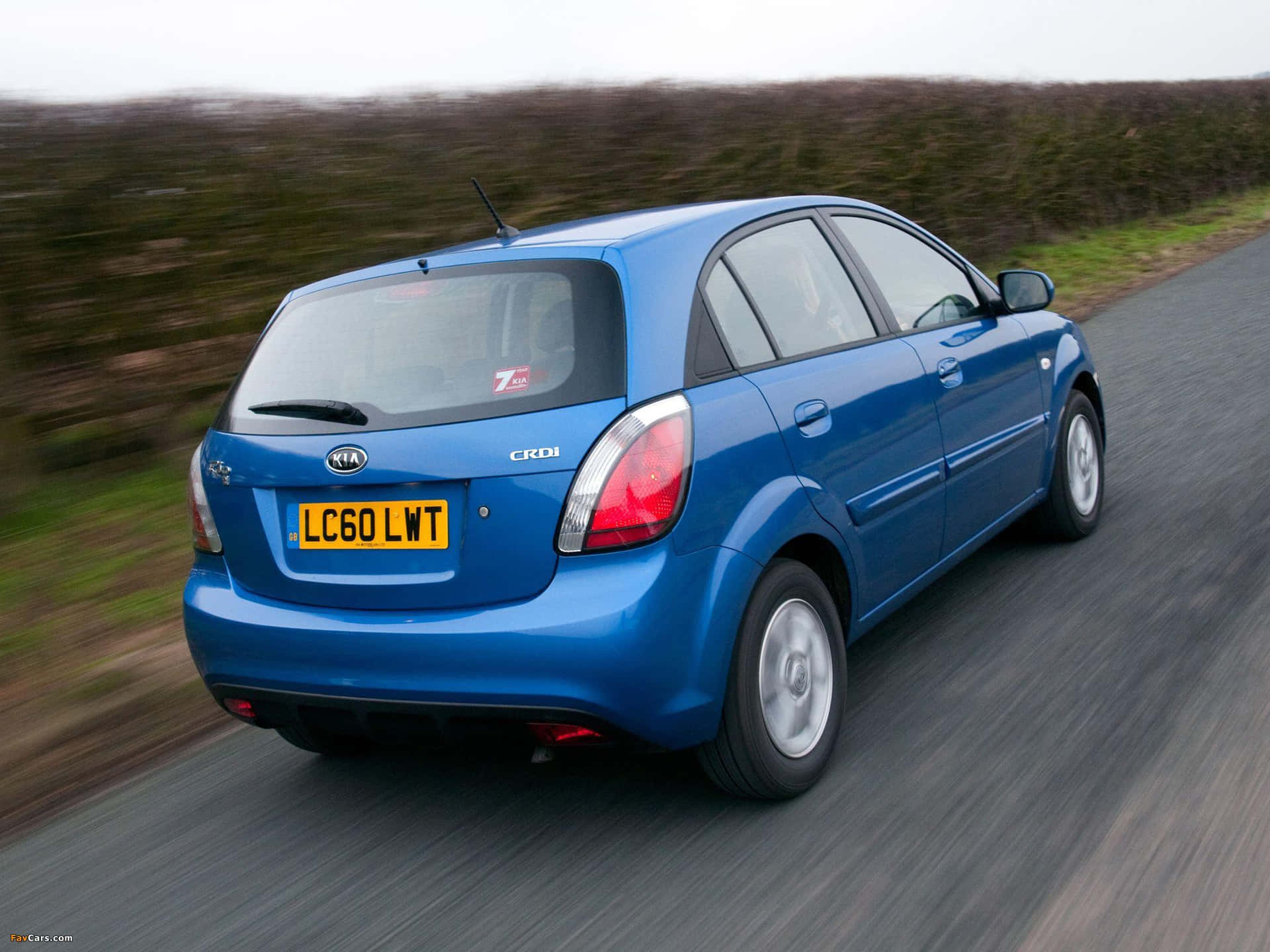 Stylish Kia Rio In Dynamic Miami Blue Wallpaper