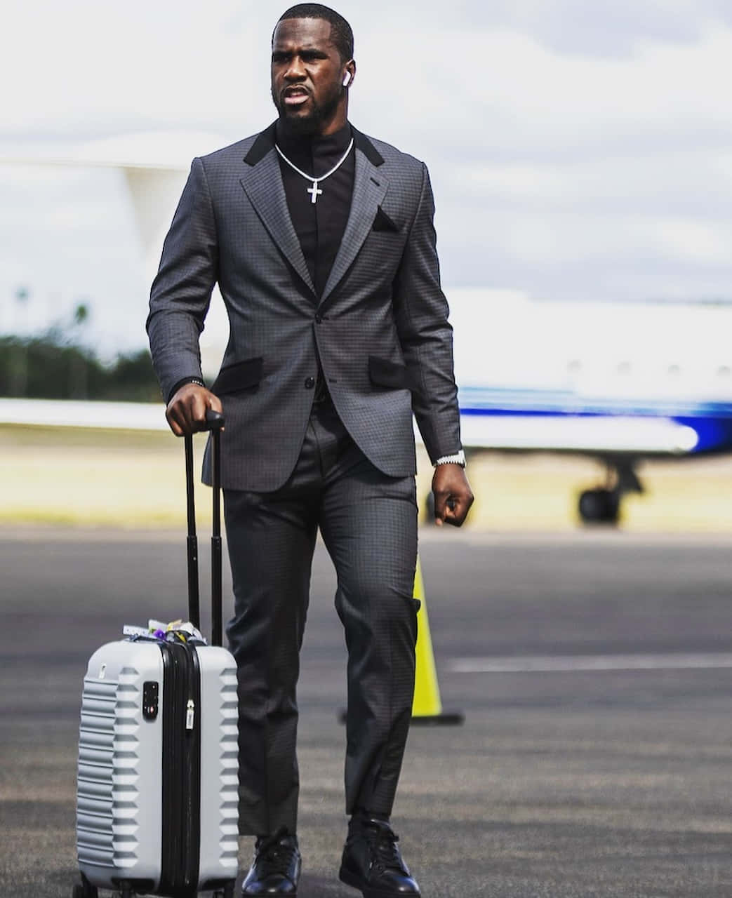 Stylish Man Walking With Suitcase Wallpaper