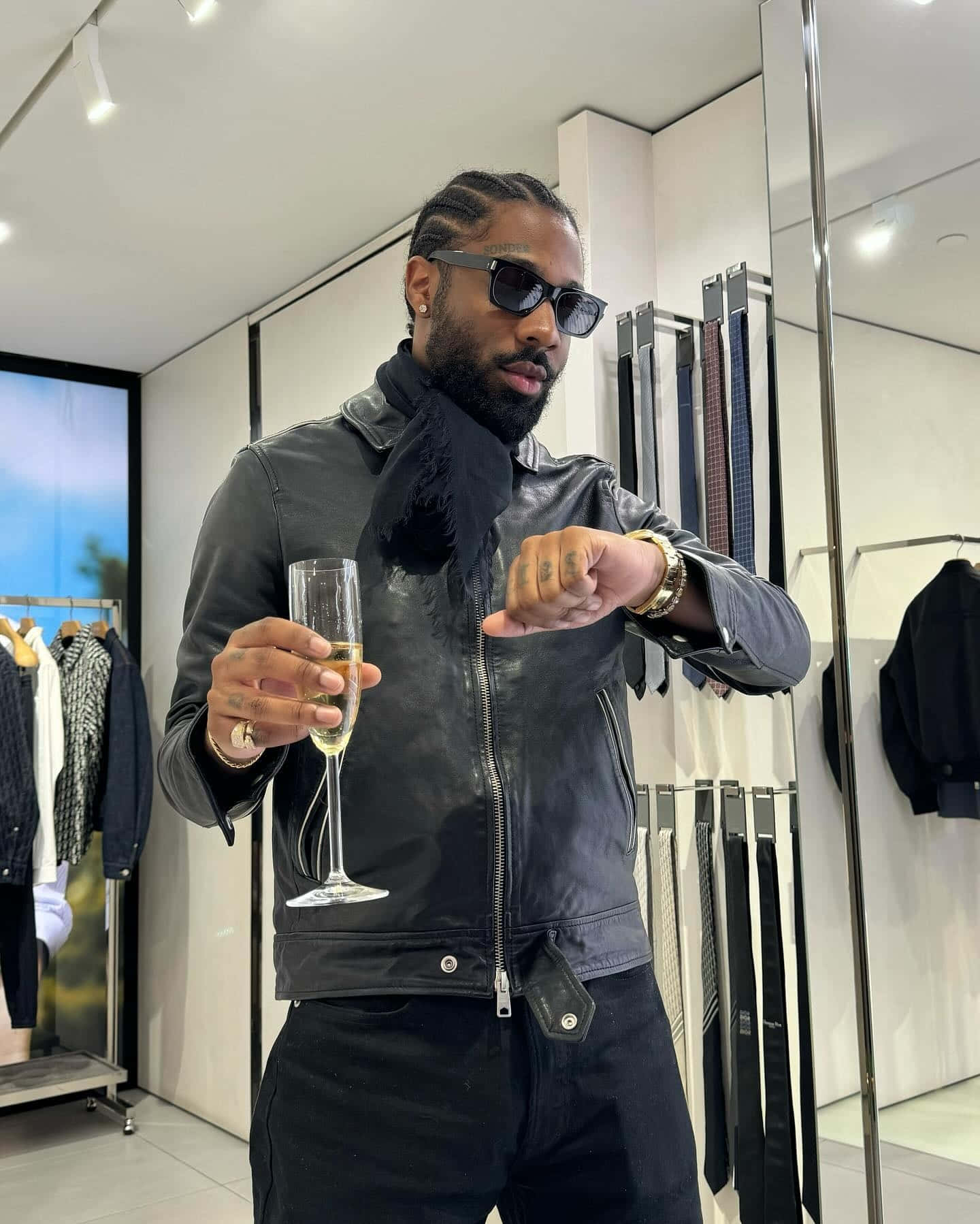 Stylish Man With Champagnein Boutique Wallpaper