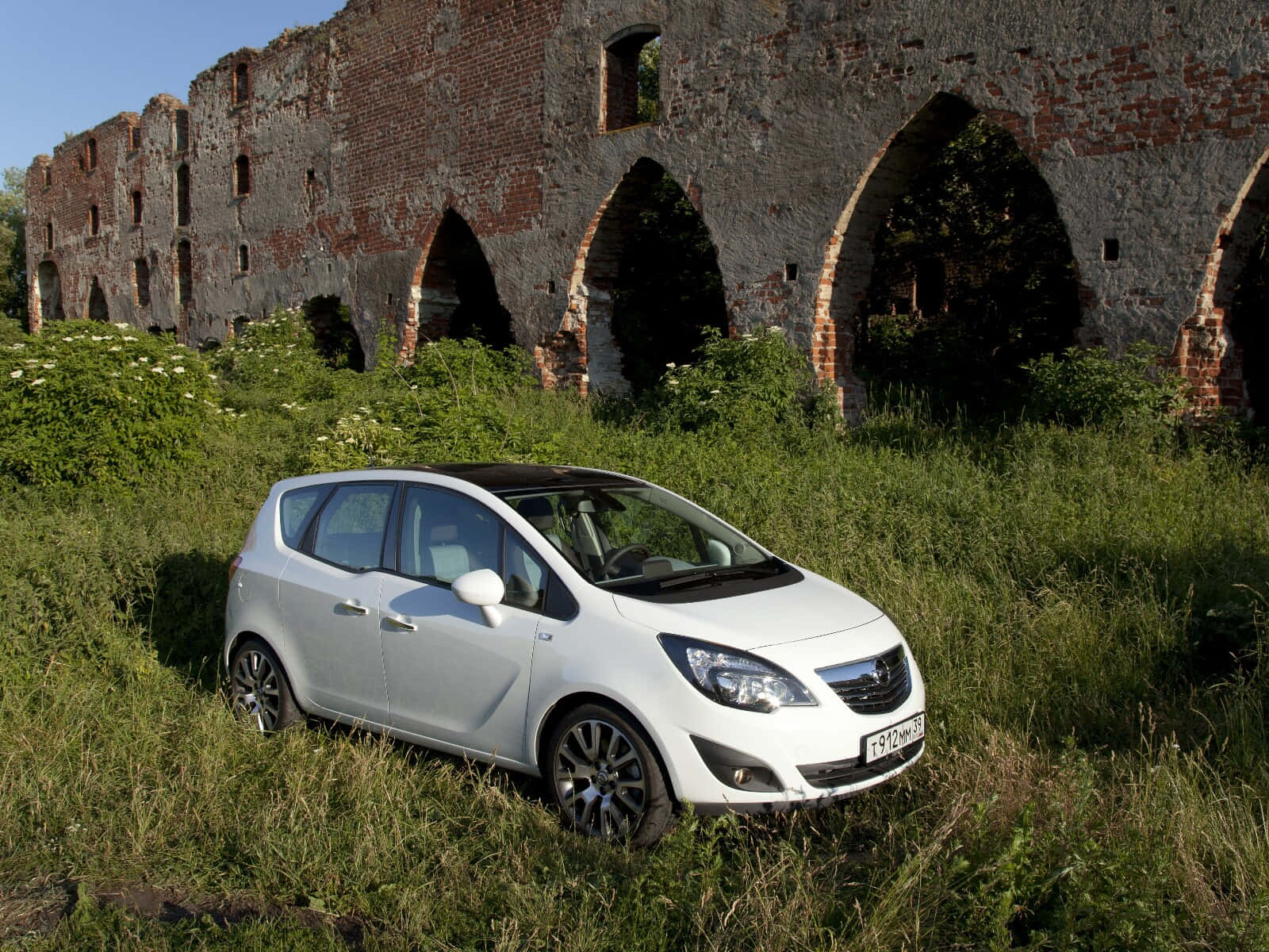 Stylish Silver Opel Meriva Parked On A Quiet Road Wallpaper