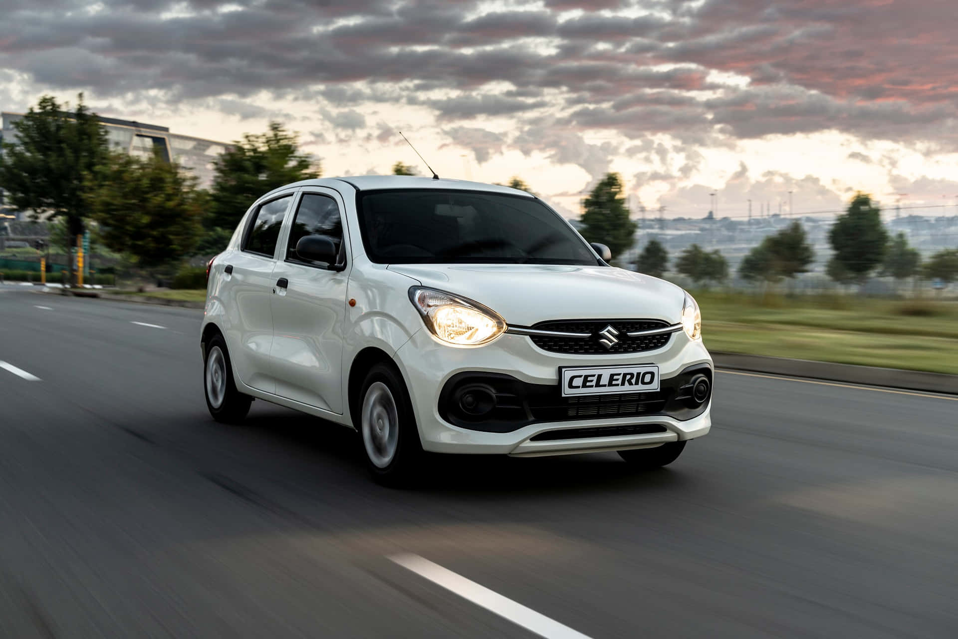 Stylish Suzuki Celerio Cruising Through Urban Streets. Wallpaper