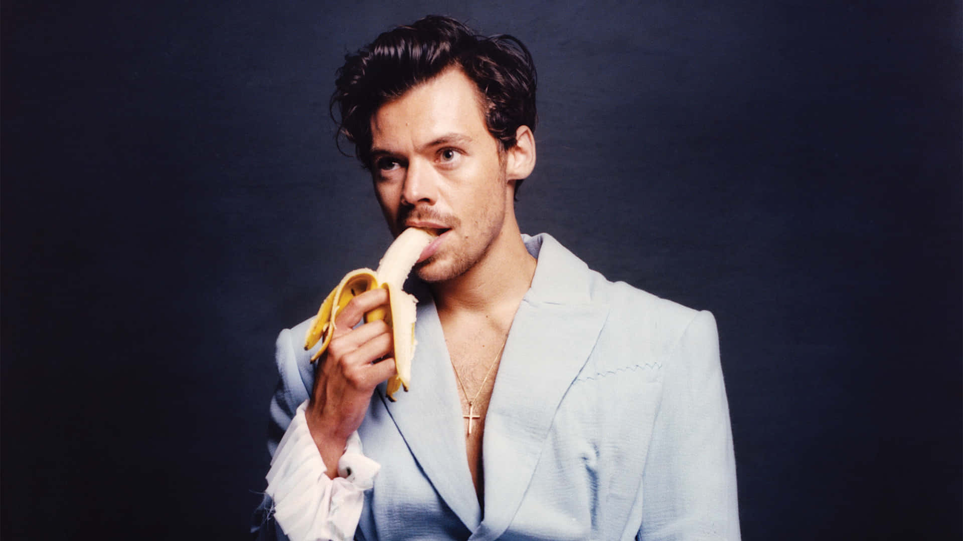 Suave Harry Styles Eating Banana [wallpaper] Wallpaper
