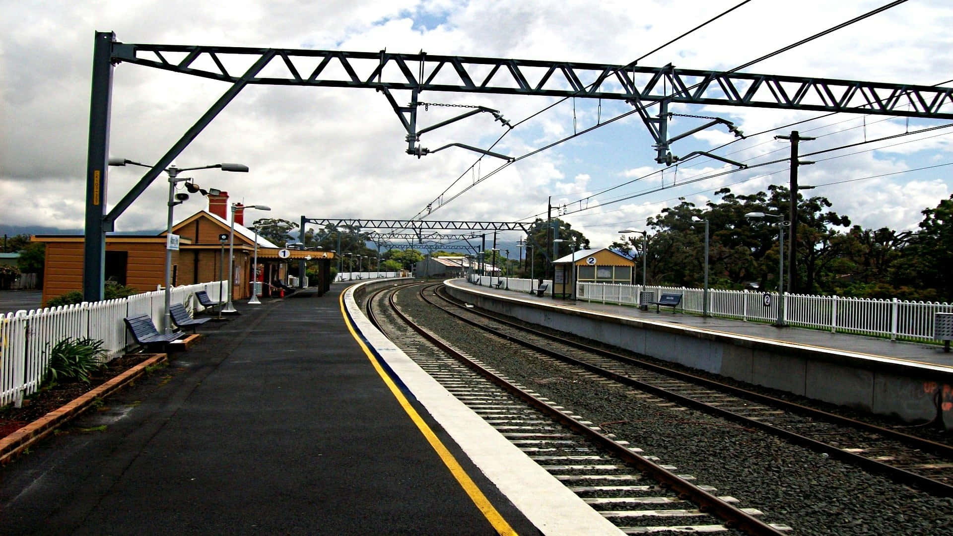 Suburban Train Station Cloudy Day Wallpaper