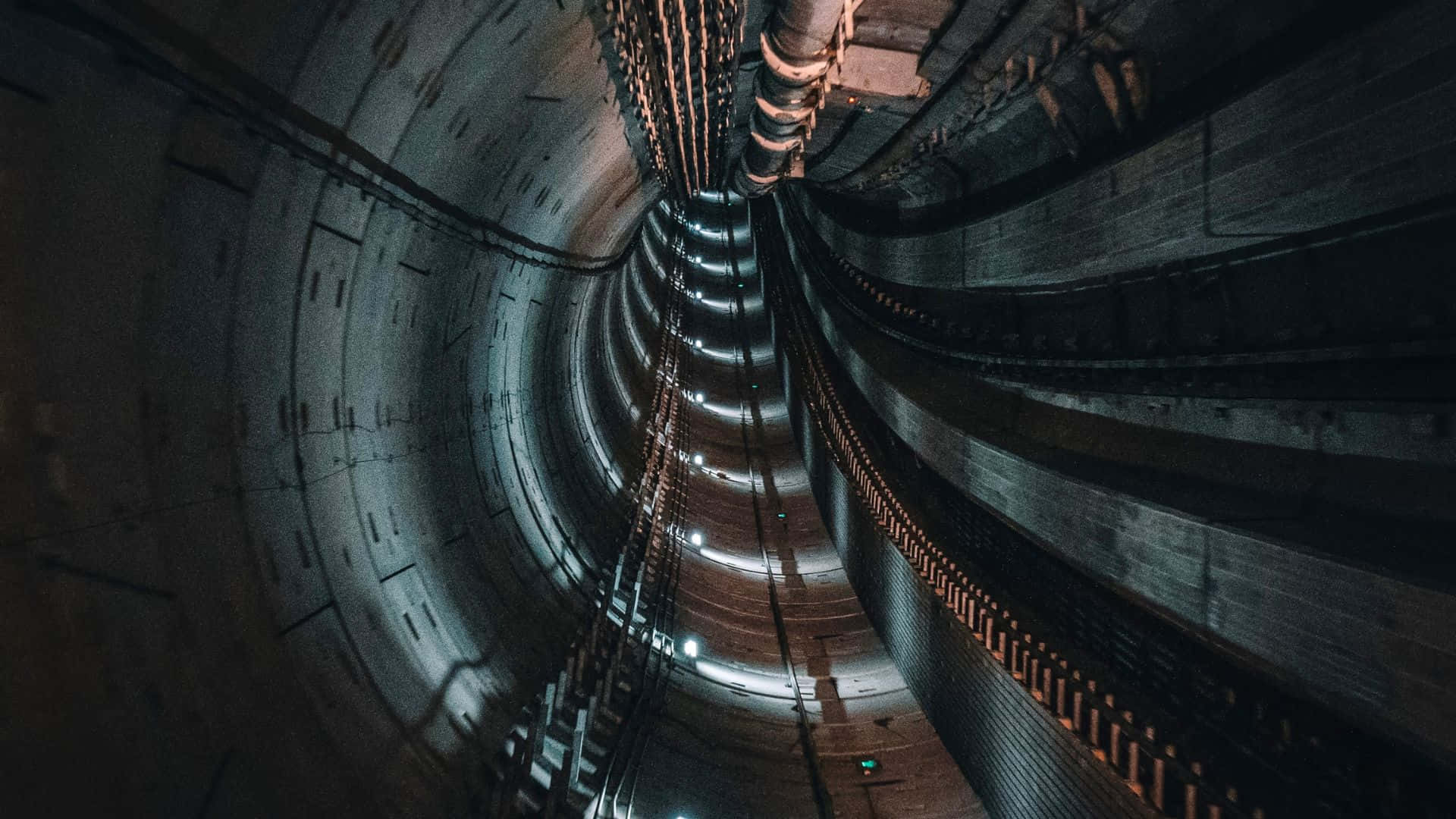 Modern subway train speeding through an underground tunnel.