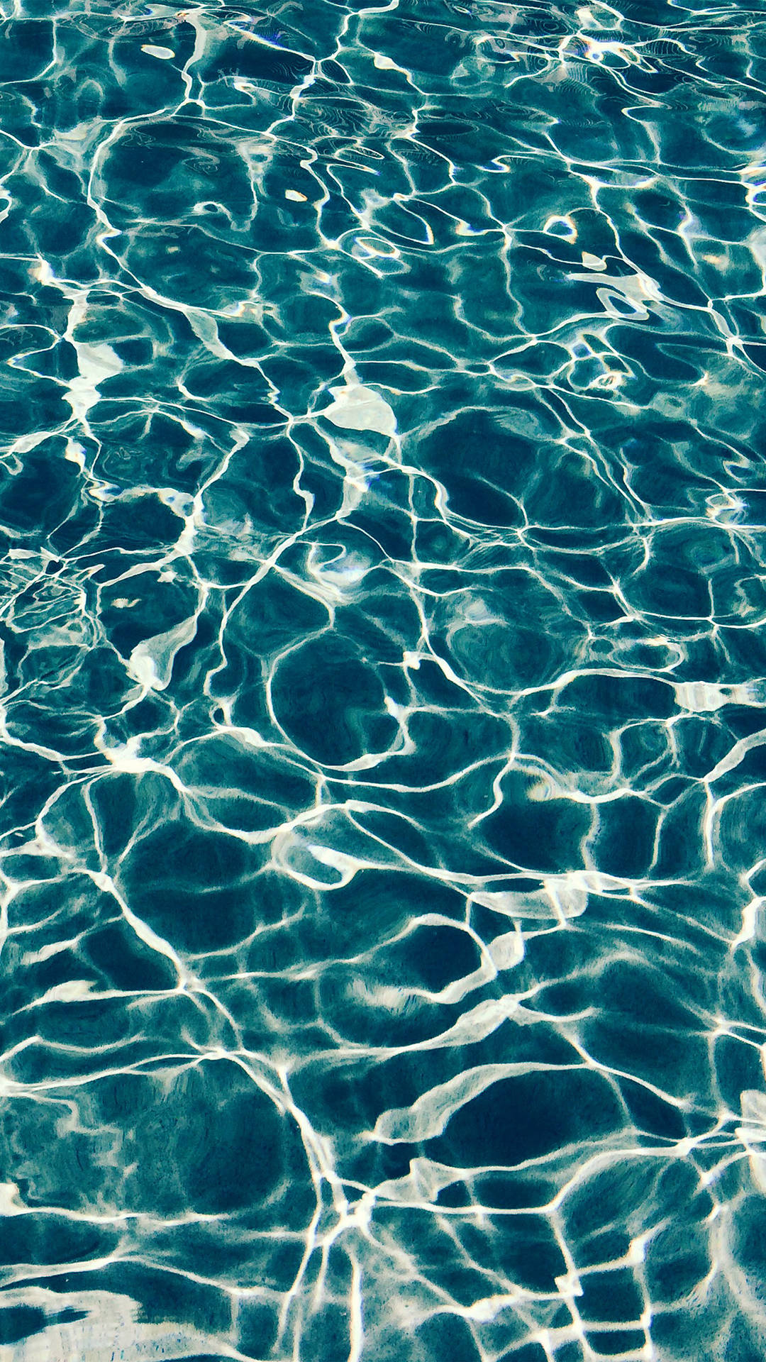 A Close Up Of A Blue Pool With Ripples Wallpaper