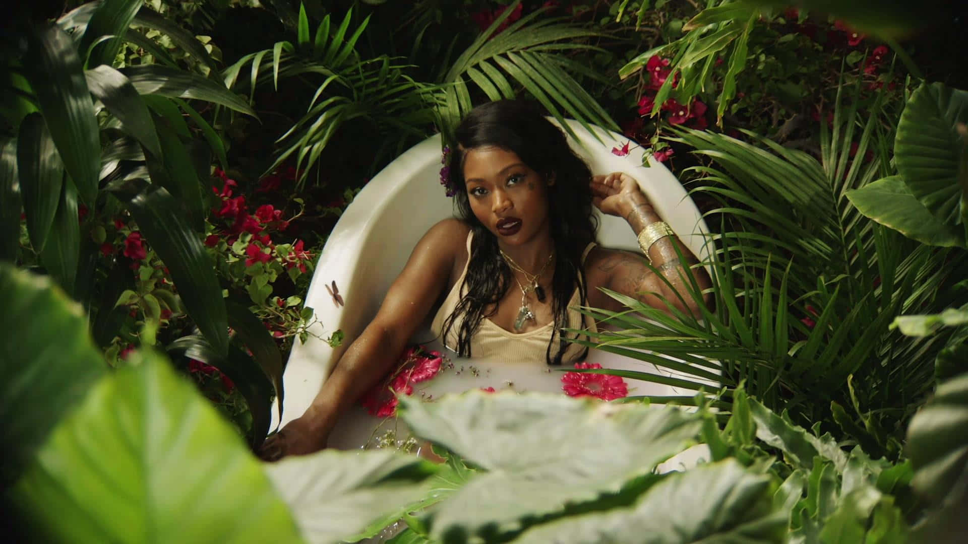 A Woman In A Tub Surrounded By Plants