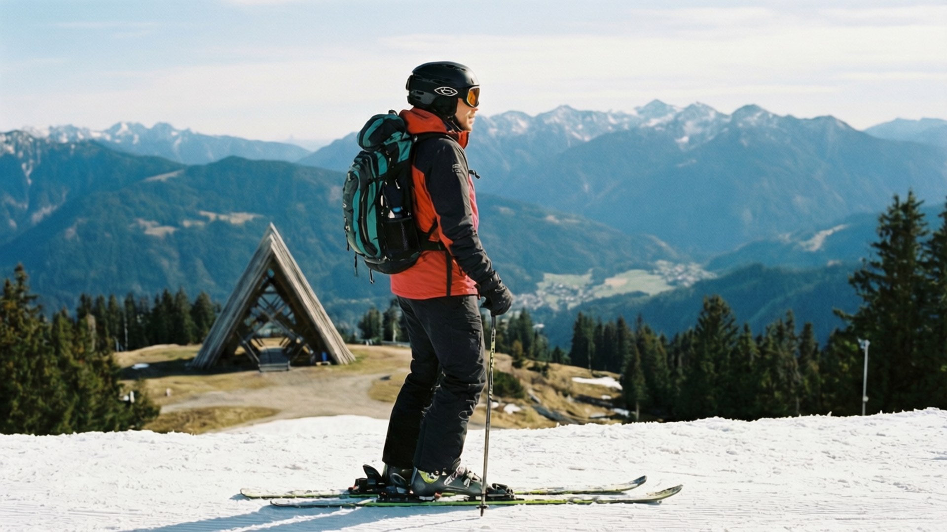 Skier admiring view from mountain peak