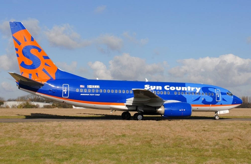 Sun Country Aircraft With Orange Logo Wallpaper