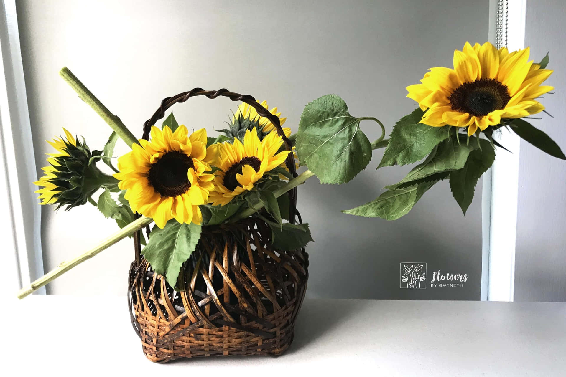 A Wicker Basket With Sunflowers In It