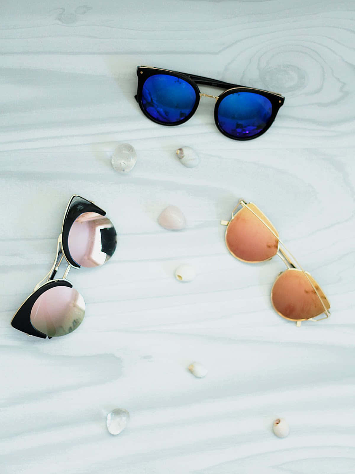 A Group Of Sunglasses On A White Surface