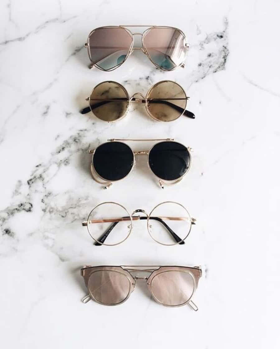 Five Different Sunglasses On A Marble Surface