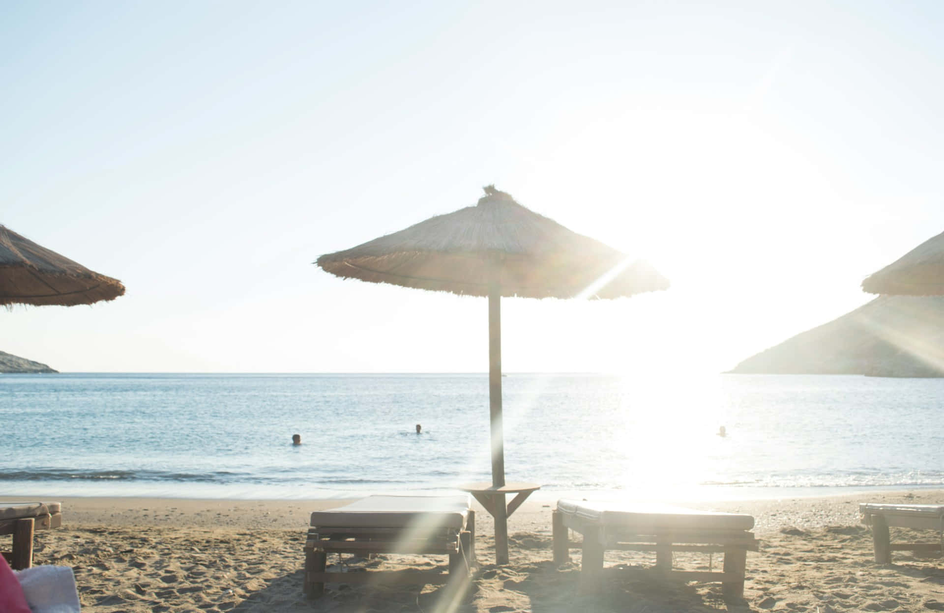 Sunlit Beach Umbrellas Wallpaper