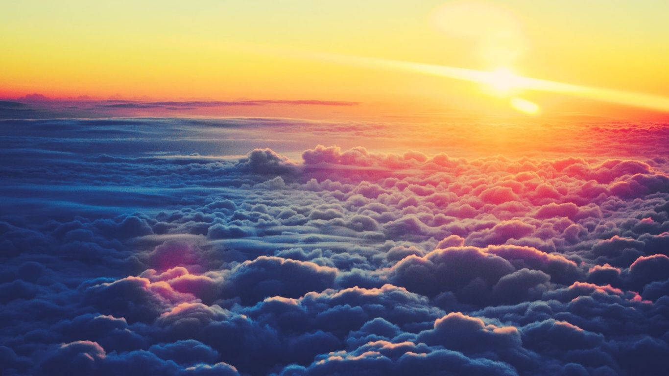 A beautiful sunny morning view above the clouds Wallpaper