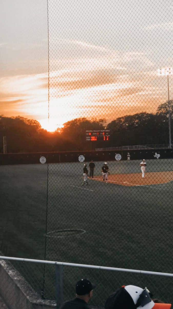 Sunset Baseball Game Through Netting Wallpaper
