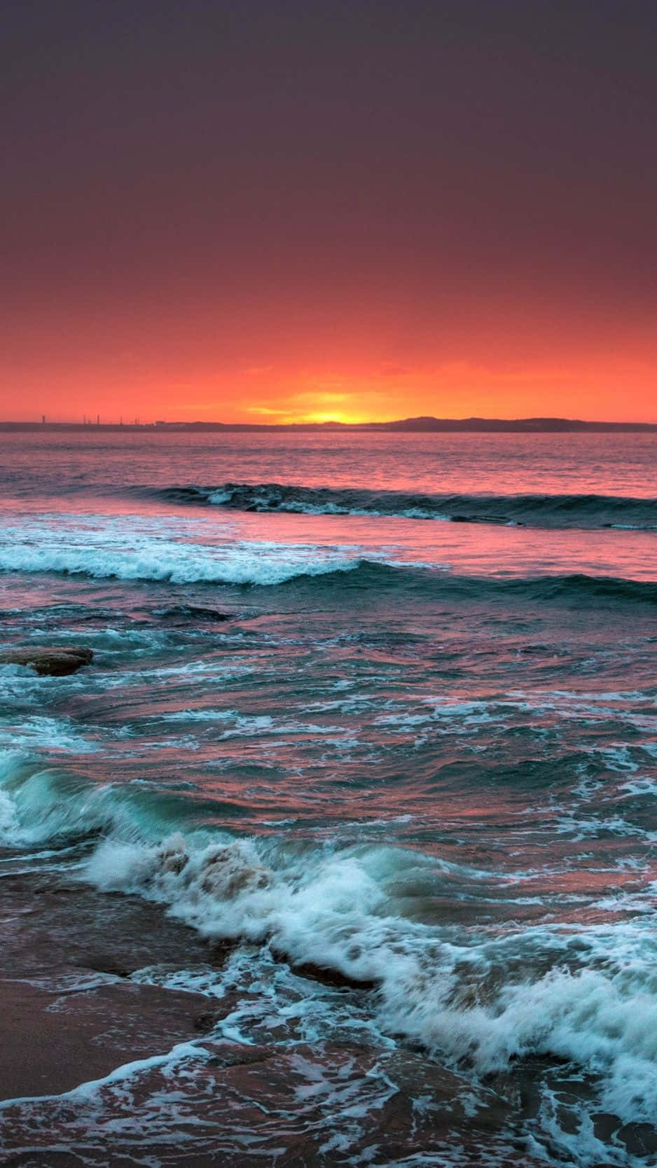 Experience the Joy of a Stunning Sunset Beach View Wallpaper