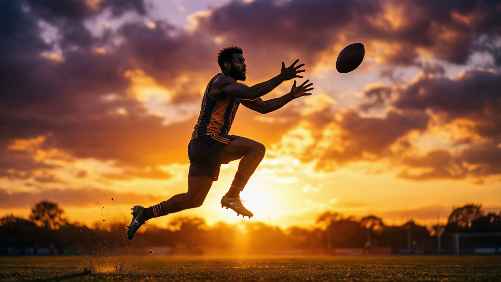 Silhouette of Rashid Shaheed leaping for a catch at sunset.