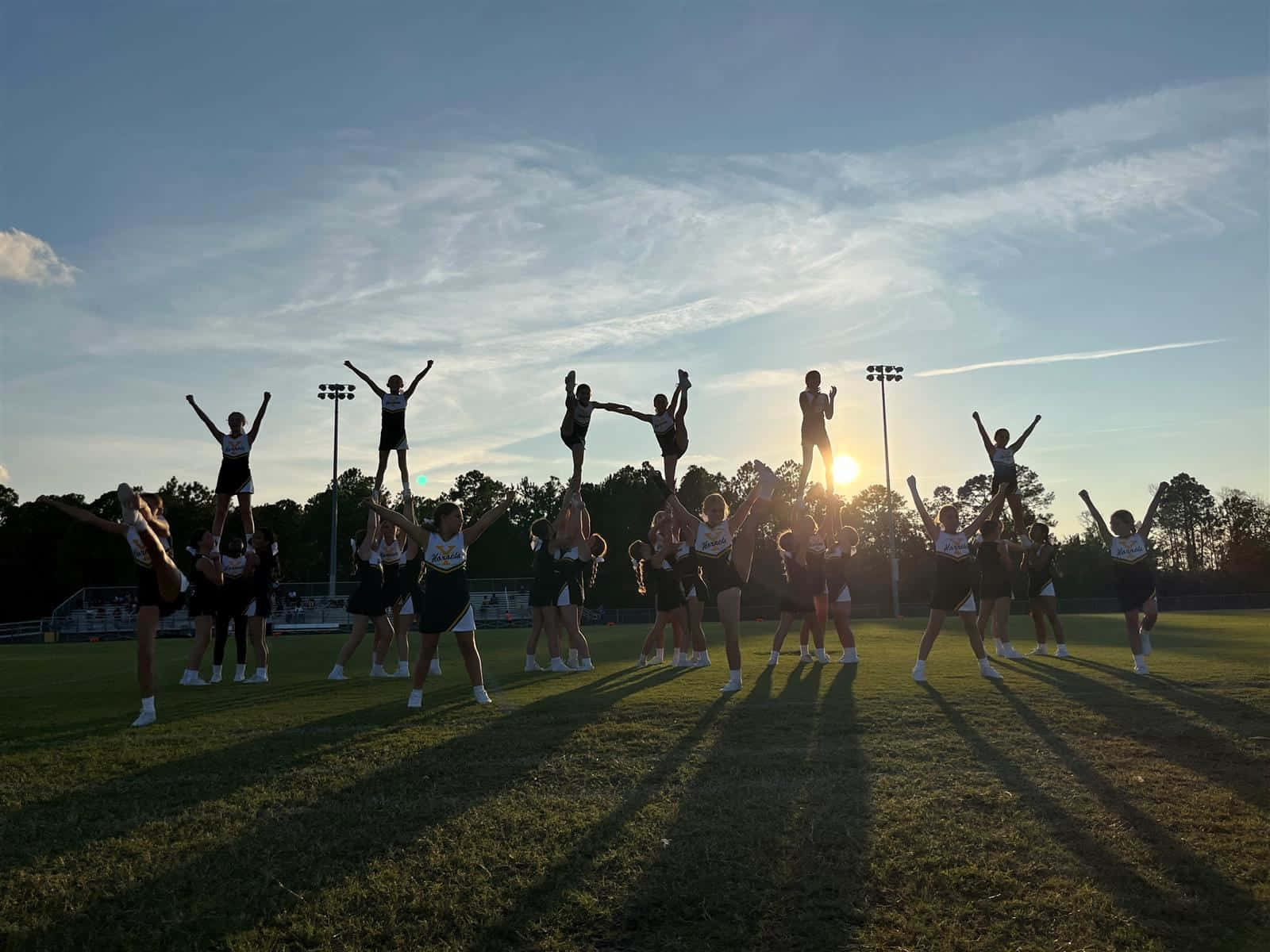 Sunset Cheerleading Practice Silhouette Wallpaper