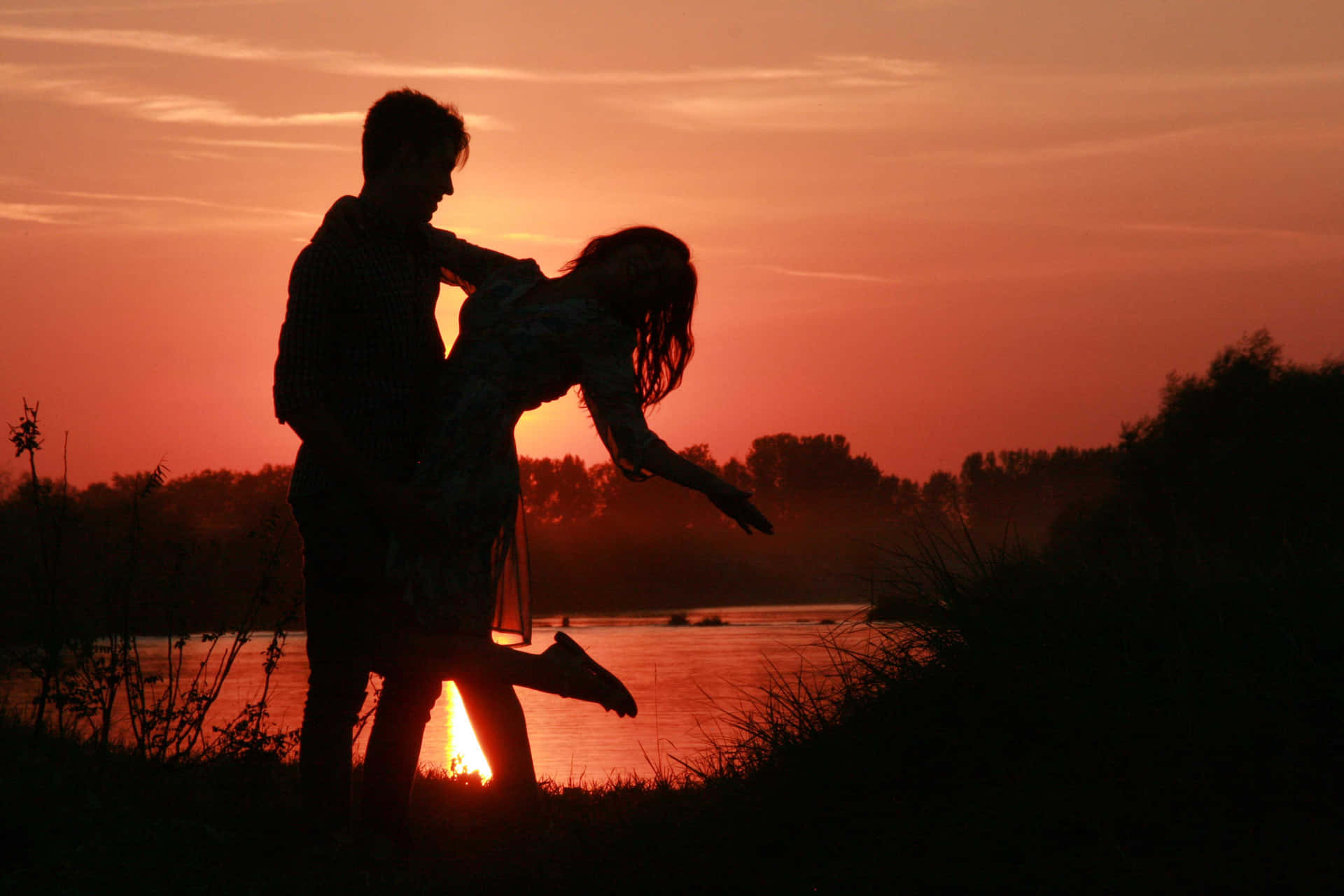 Captured Moments of Love: Couple Embracing Under a Breathtaking Sunset