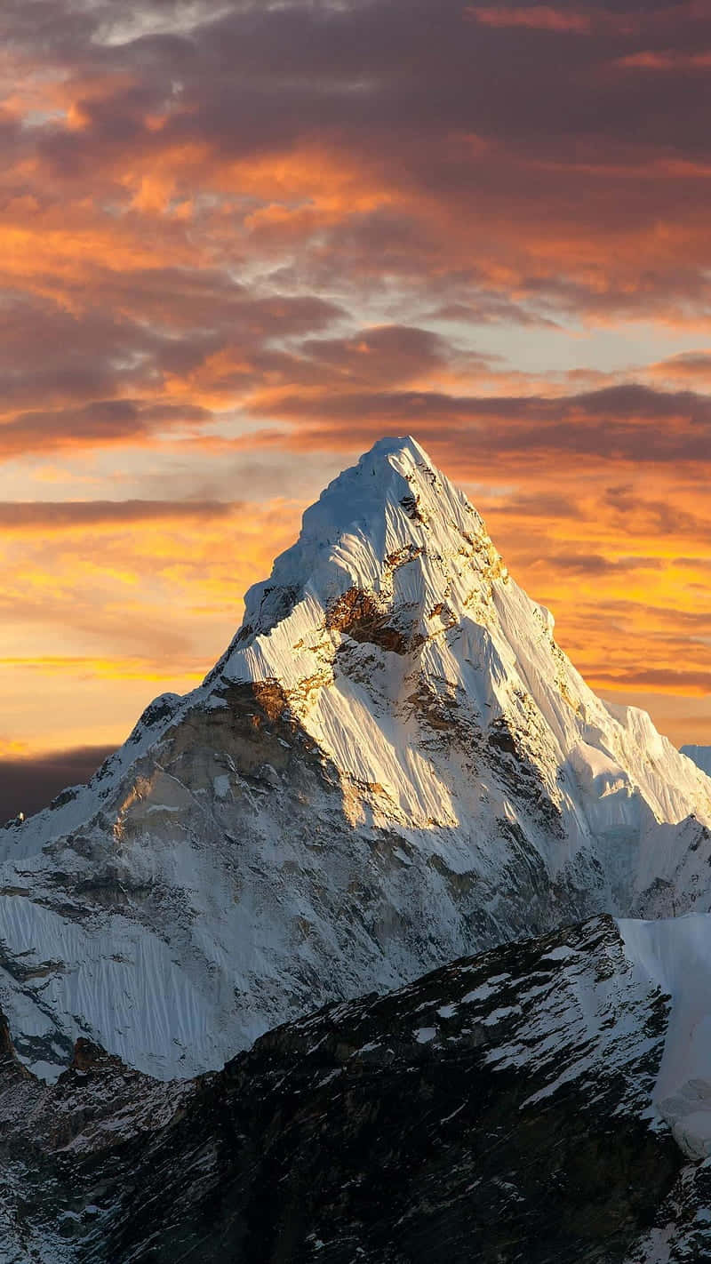 Sunset_ Glow_ Over_ Snowy_ Mountain_ Peak Wallpaper