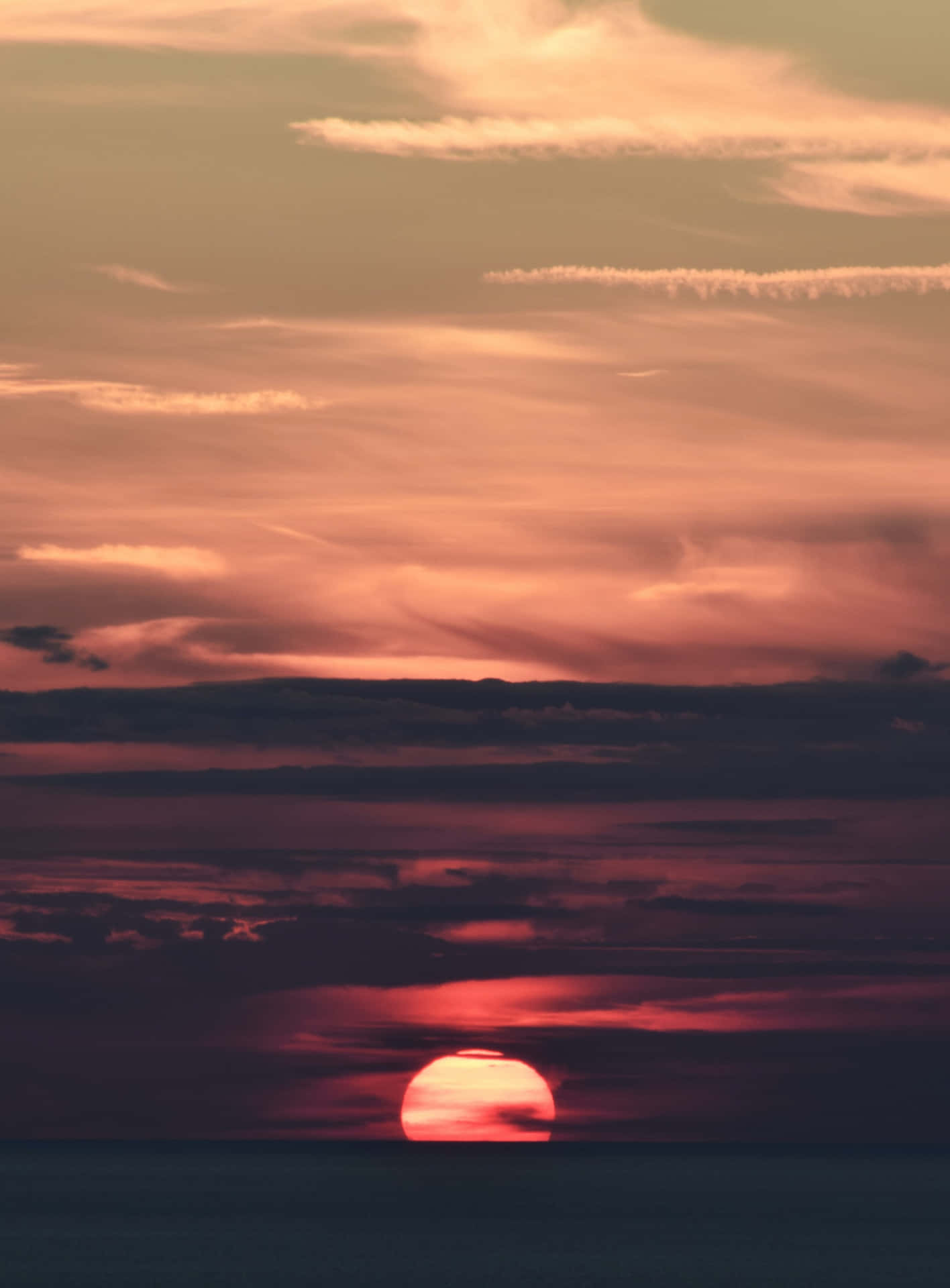 Blazing Sunset Hues Radiating in the Sky Wallpaper