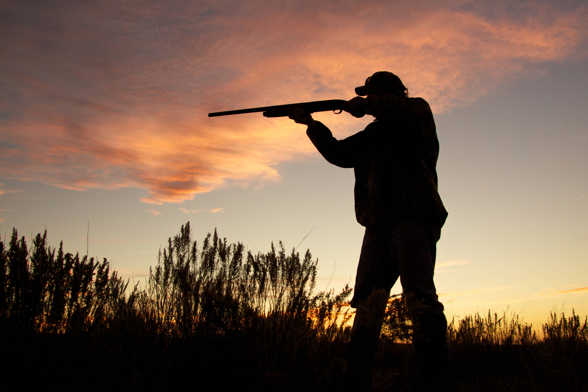 Enjoying a beautiful sunset during a successful hunting trip Wallpaper