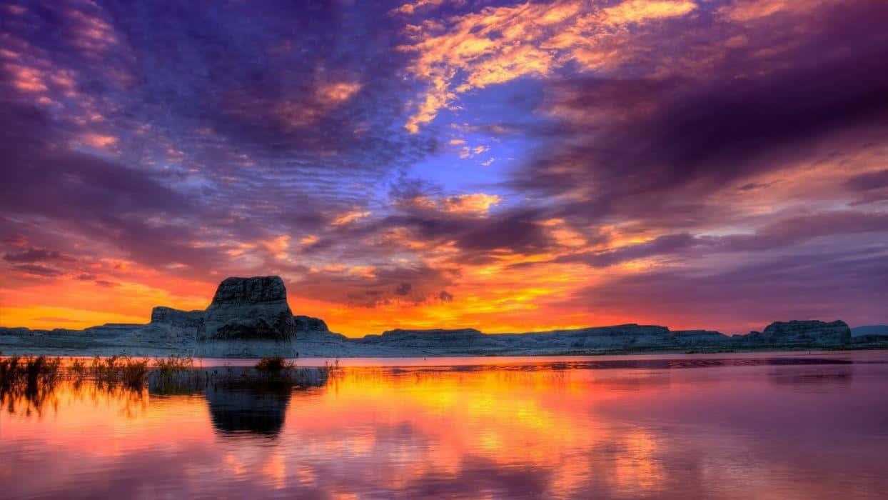 Majestic Sunset Over a Tranquil Landscape Wallpaper