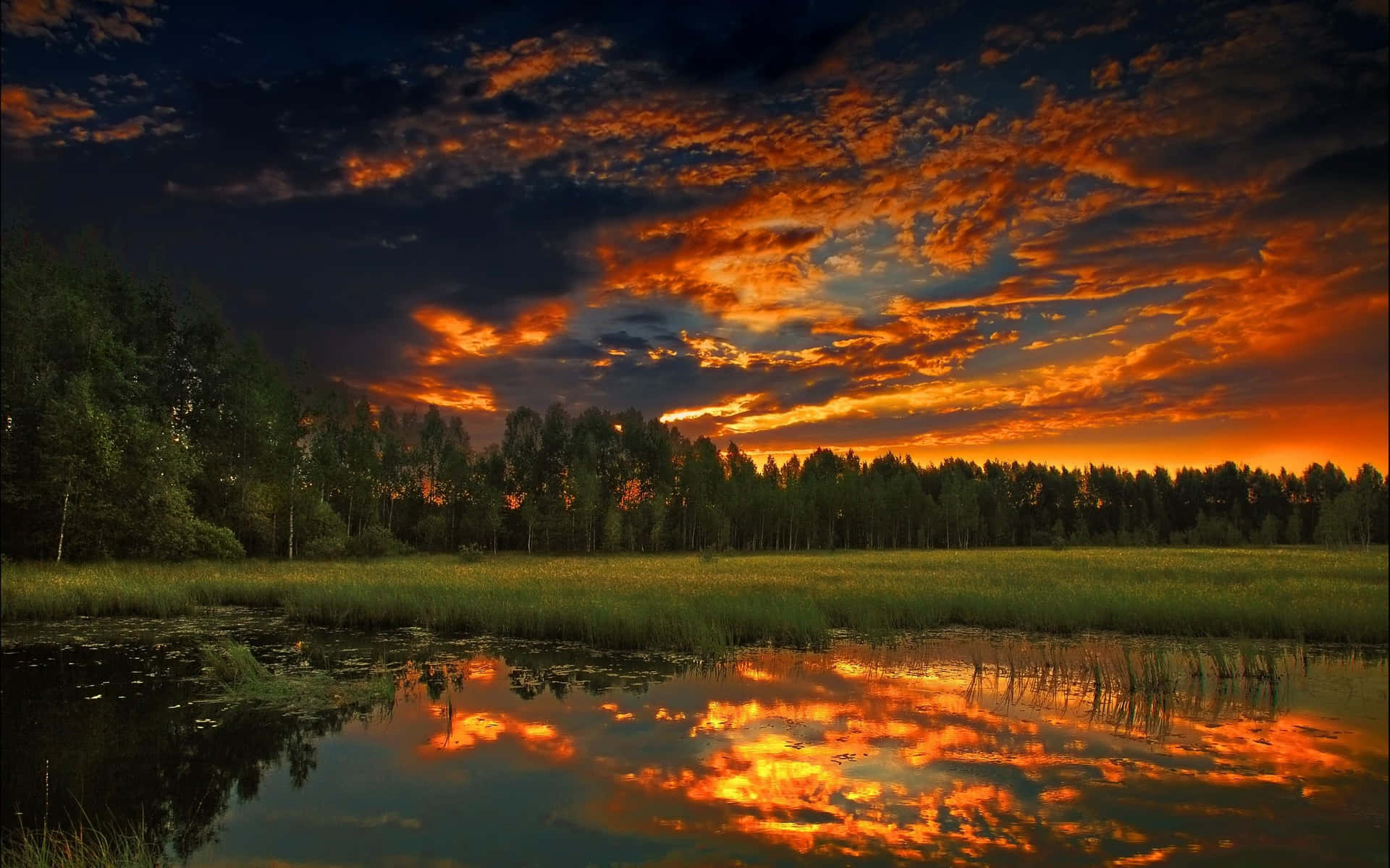 A Stunning Sunset Reflection Over a Calm Lake Wallpaper