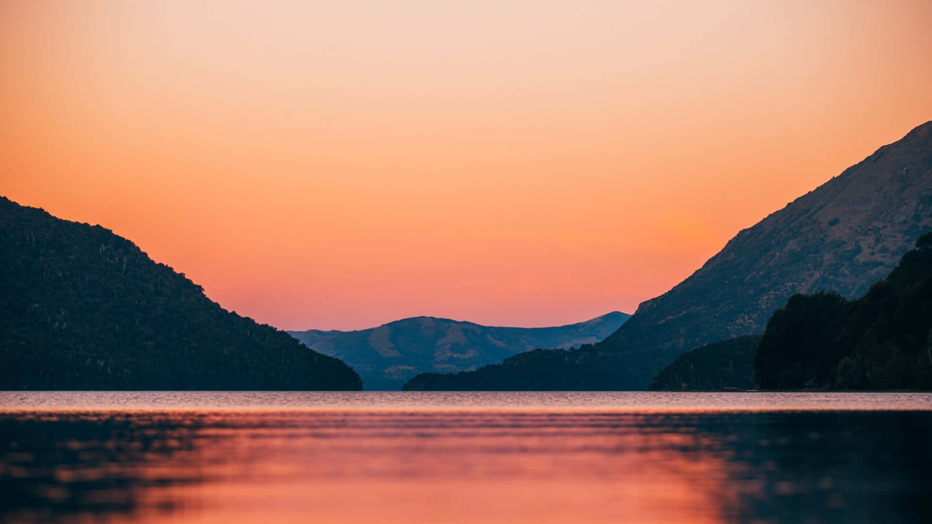 Sunset_ Serenity_ Lake_ Between_ Mountains.jpg Wallpaper