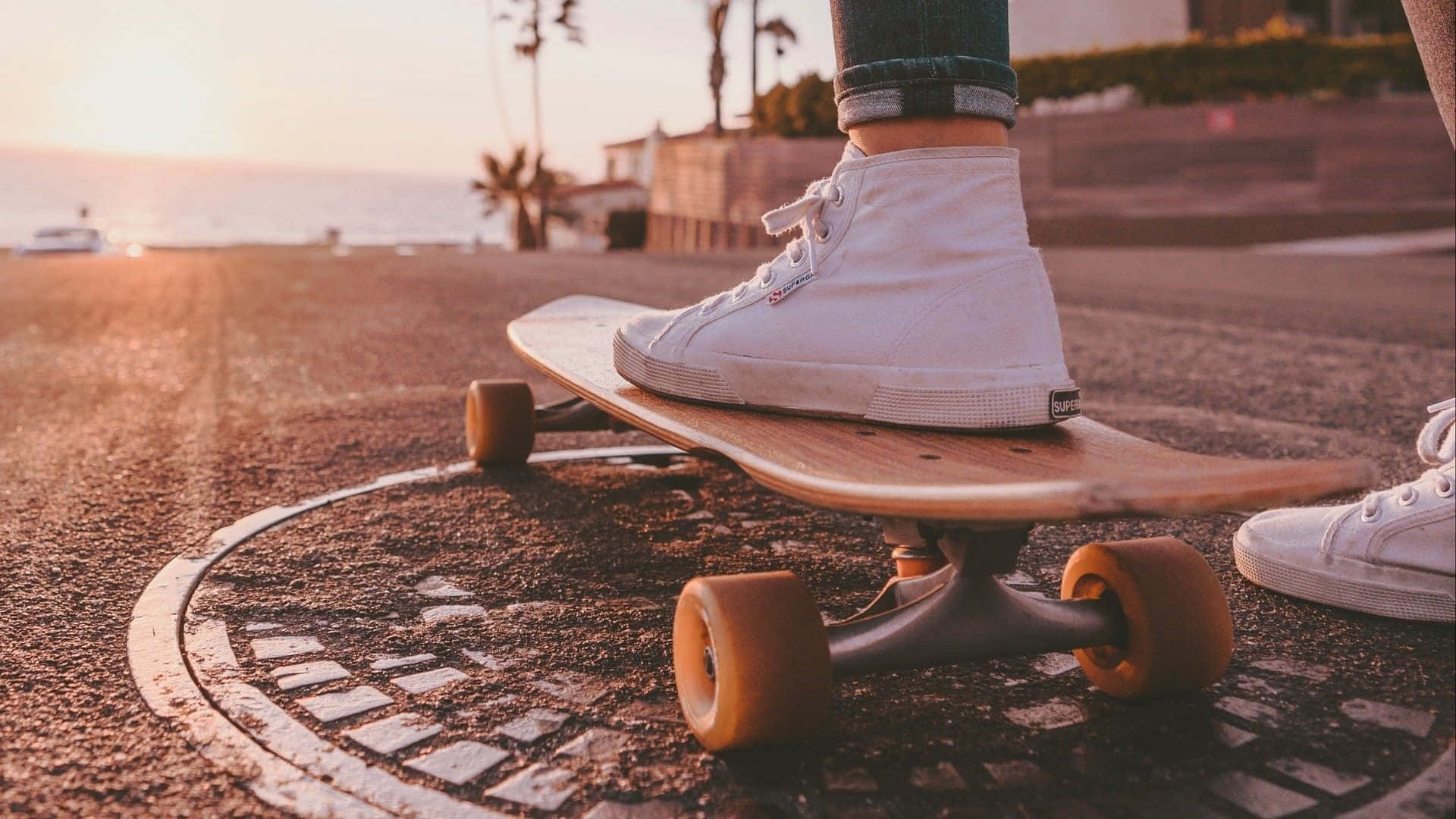 Sunset Skateboardingon Coastal Road.jpg Wallpaper