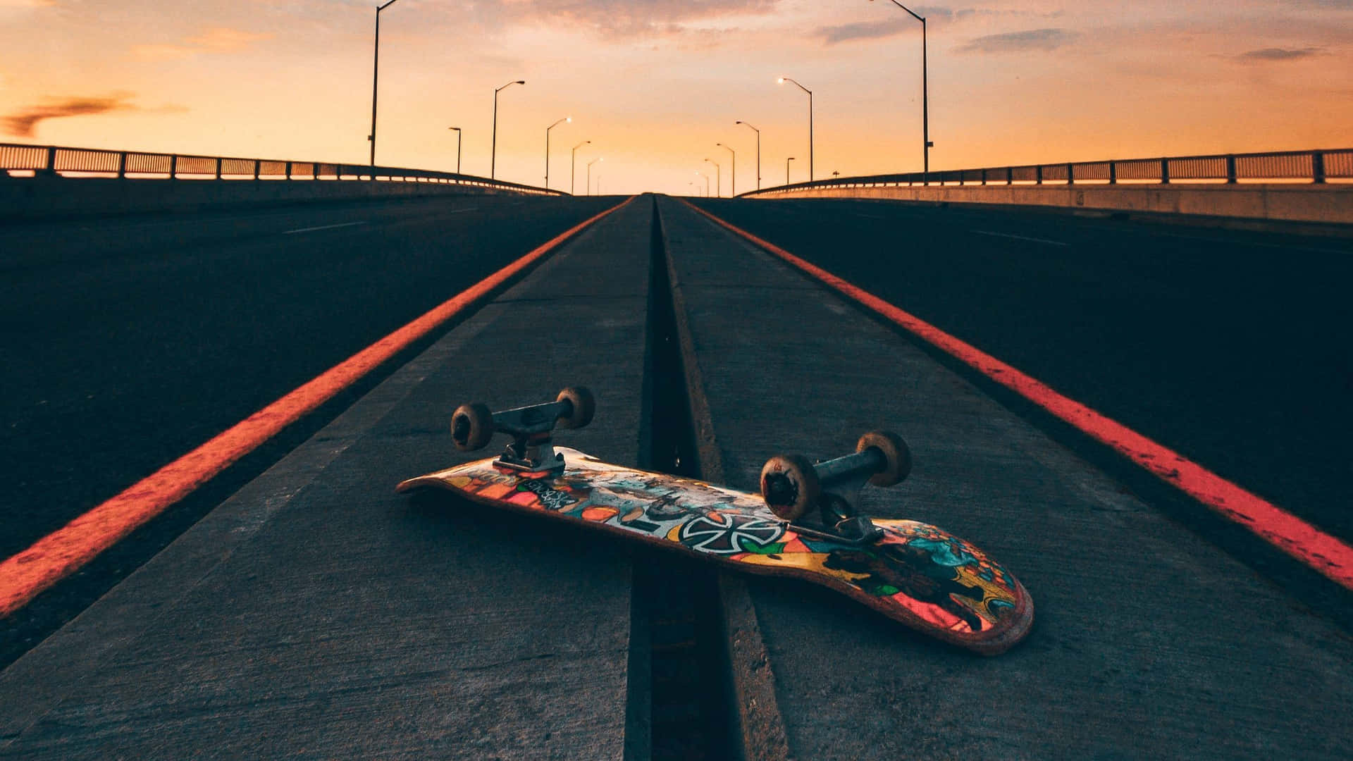 Sunset Skateboardon Deserted Road.jpg Wallpaper