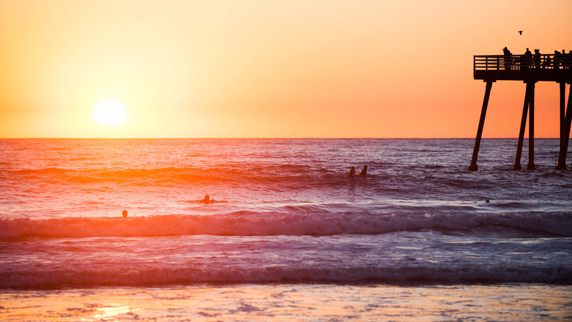 Sunset Surfers Beach Pier Silhouette Wallpaper