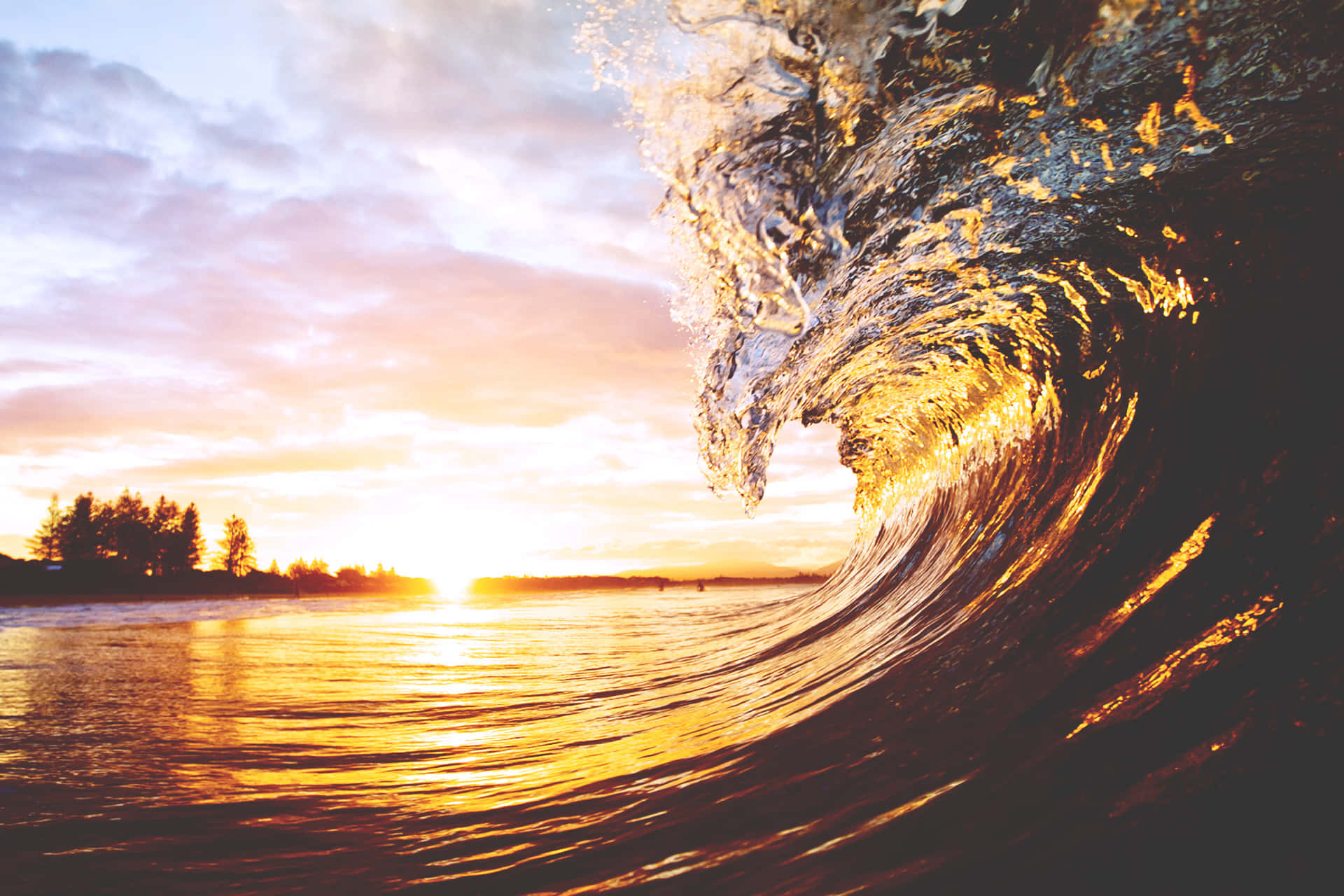 A Peaceful View of the Setting Sun Reflected by a Wave Wallpaper