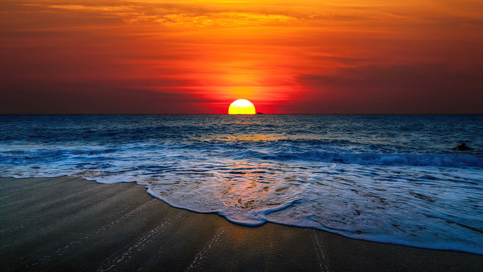Enjoy the tranquility of the ocean as the sun sets Wallpaper