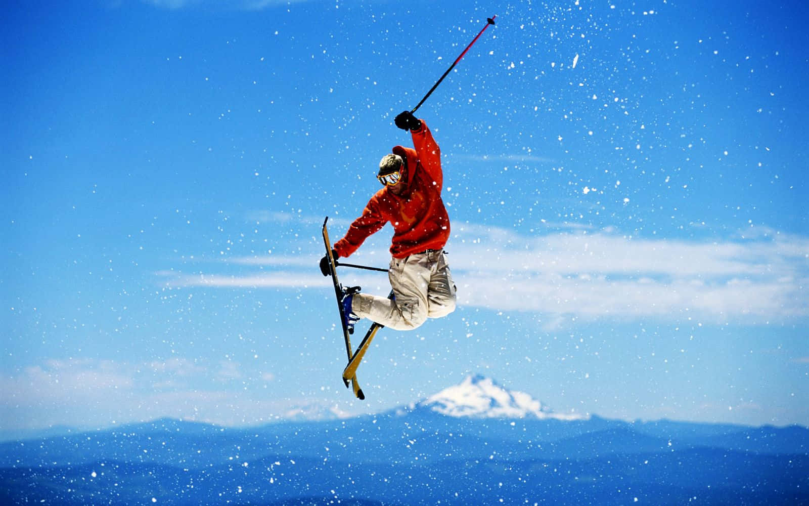 Surreal Skiing Adventure In Snow-covered Mountains Wallpaper