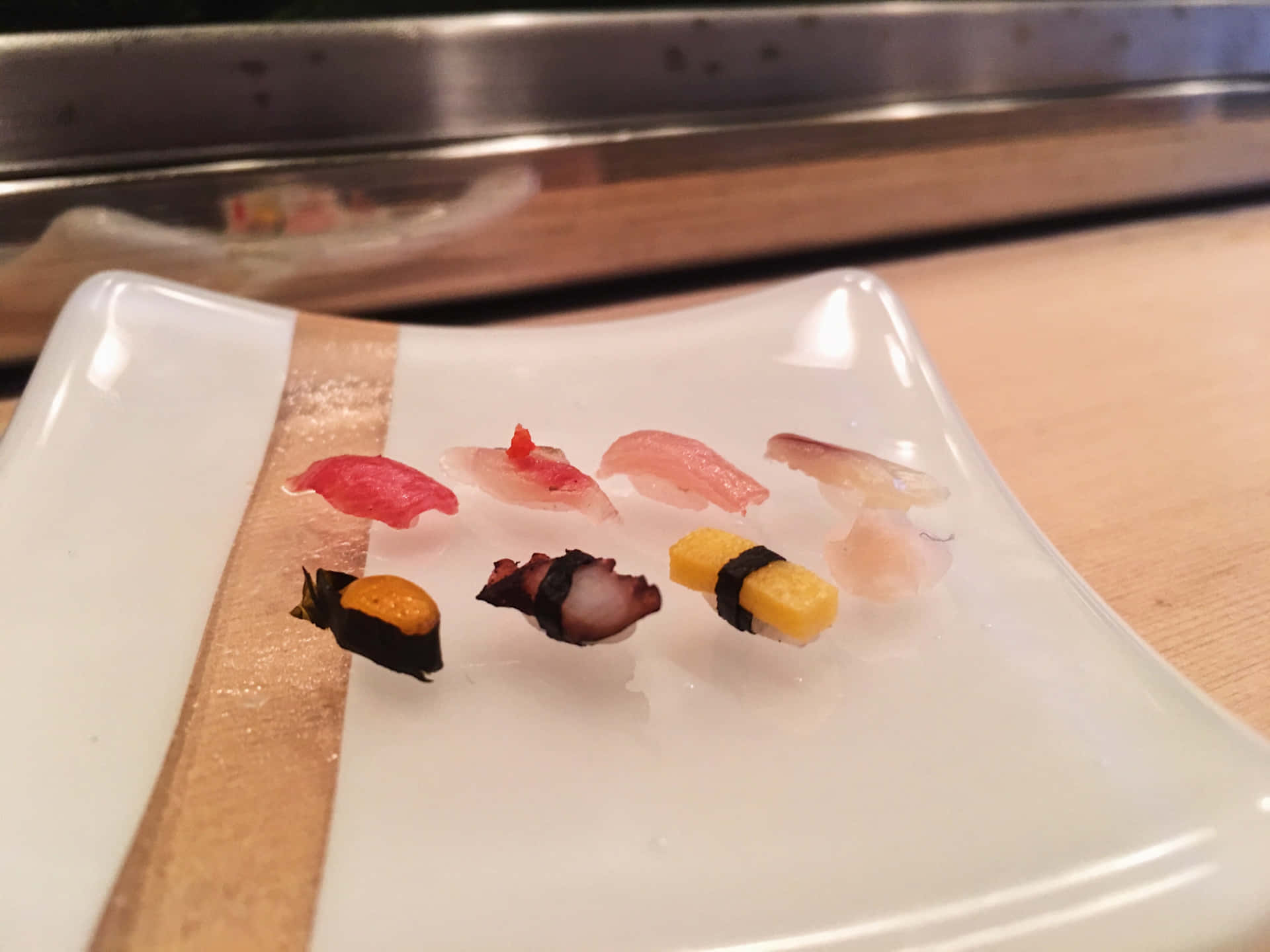 A feast of assorted sushi rolls on a wooden table