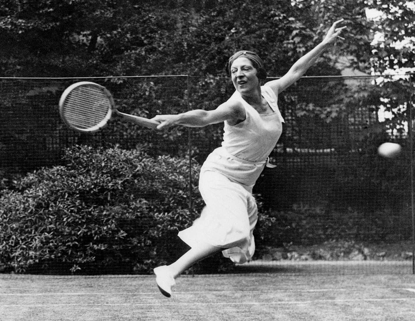 Caption: Suzanne Lenglen in action with a classic backhand stance Wallpaper