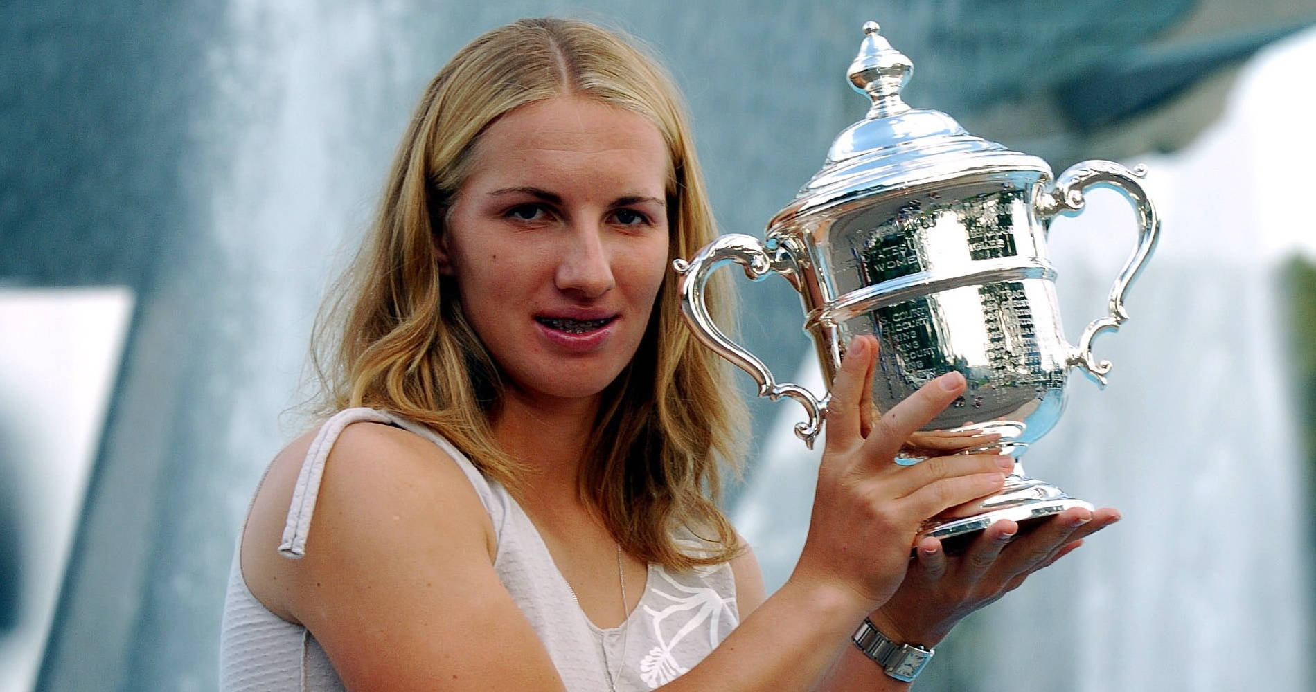 Champion Svetlana Kuznetsova Holding Up Her Trophy Wallpaper