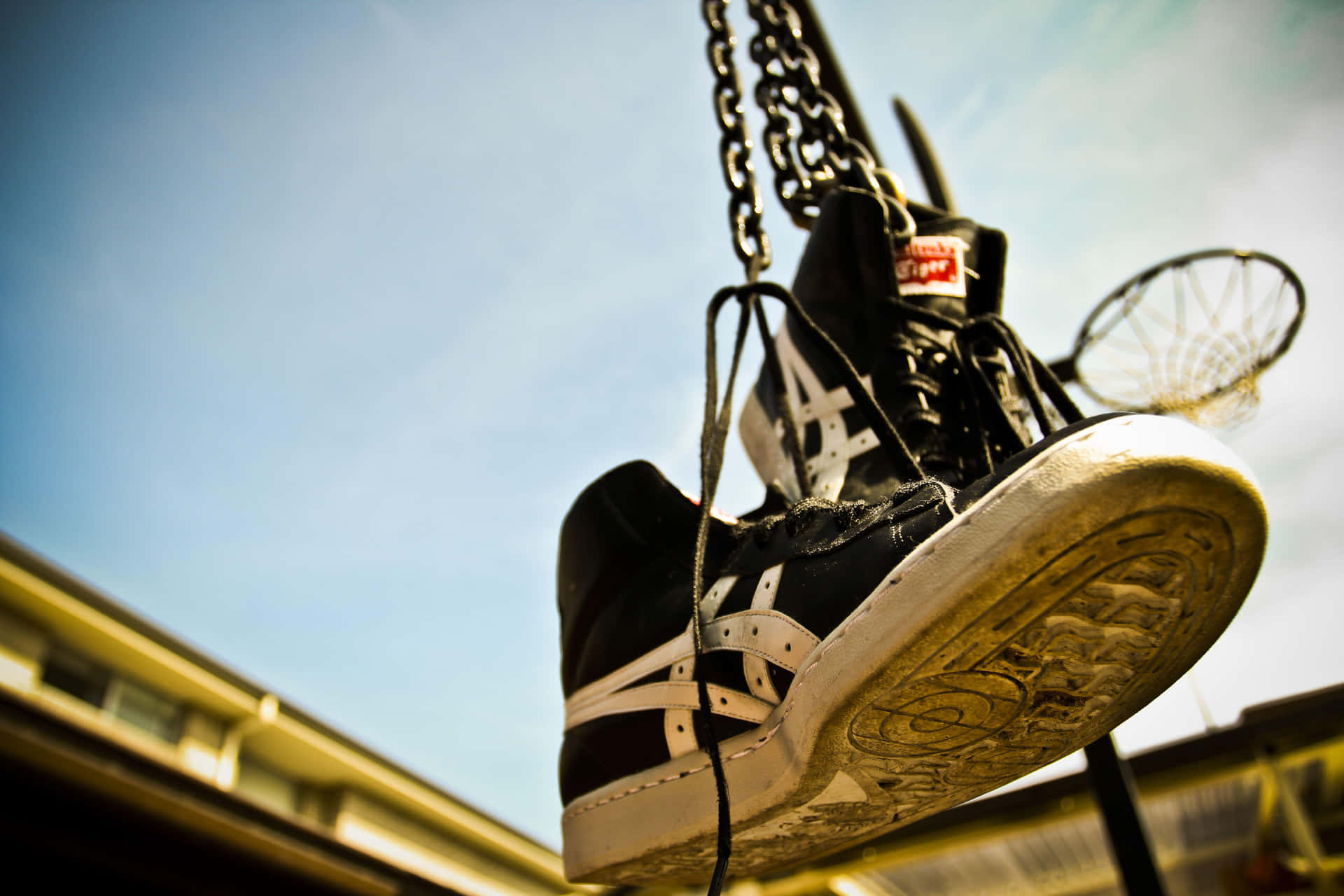 A Black And White Shoe Hanging From A Chain