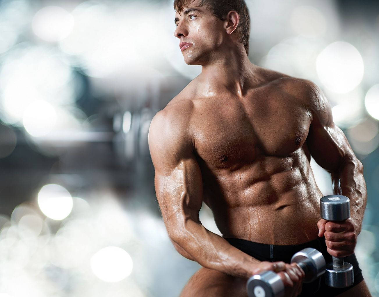 Sweaty Muscle Man With Dumbbells Wallpaper
