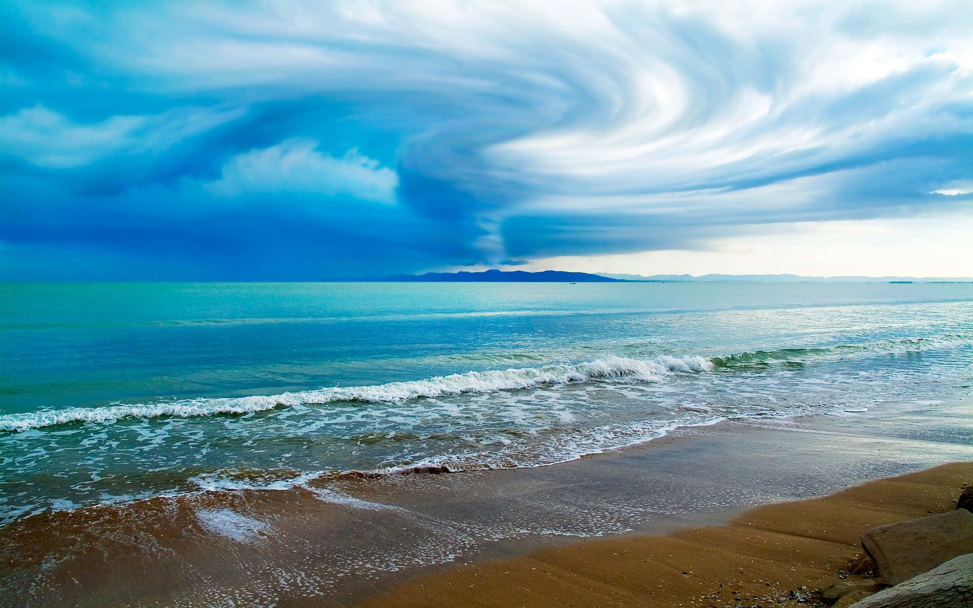 Sweeping Blue Beach Storm Clouds Wallpaper