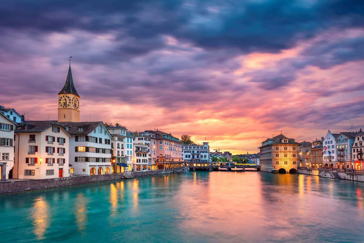 Sweeping View Of Zurich City Skyline At Sunset Wallpaper